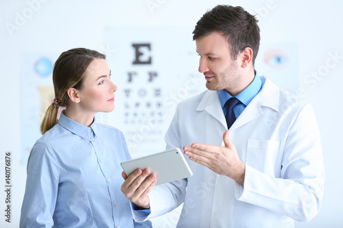 Woman visiting male ophthalmologist in clinic