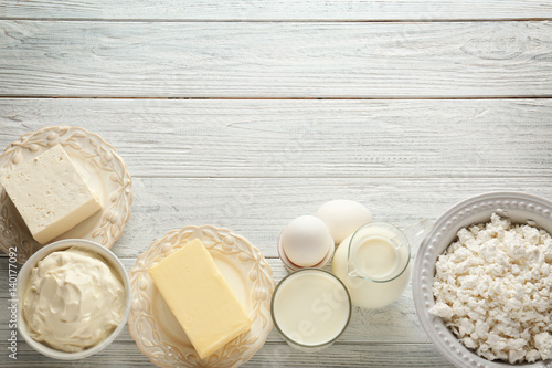 Different dairy products on wooden table photo