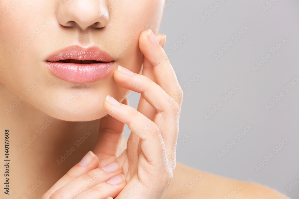 Fototapeta premium Face of young woman on light background