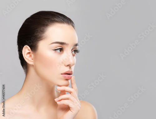 Woman with cold sore touchi...