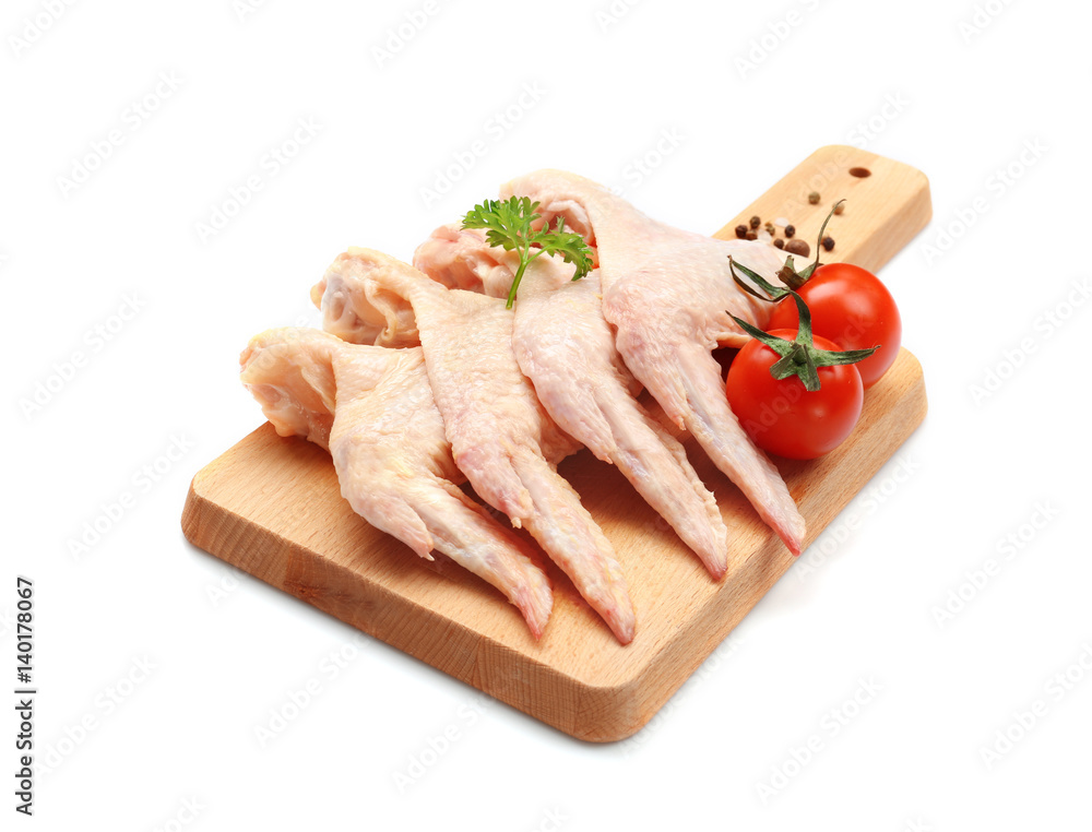 Wooden board with fresh raw chicken wings on white background Wooden board with fresh raw chicken wings on white background
