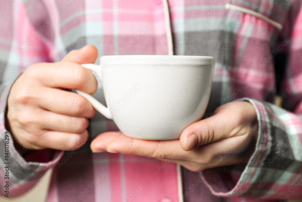 Blank white cup in hands, closeup Blank white cup in hands, closeup