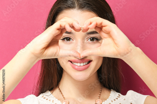 Beautiful young woman makin...
