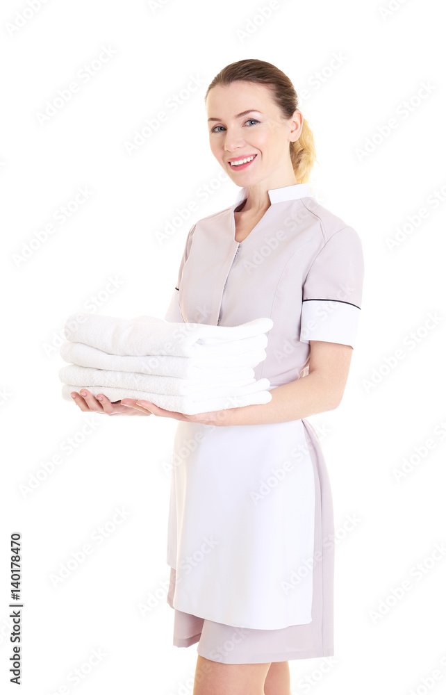 Attractive chambermaid holding pile of clean towels on white background Attractive chambermaid holding pile of clean towels on white background
