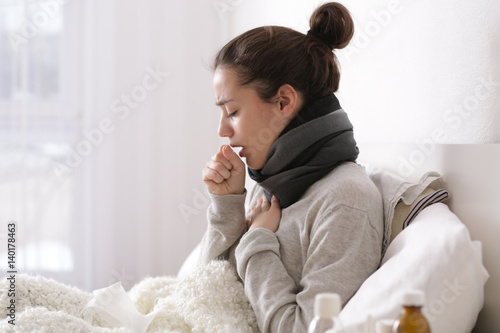 Fotografia Young ill woman in bed at home