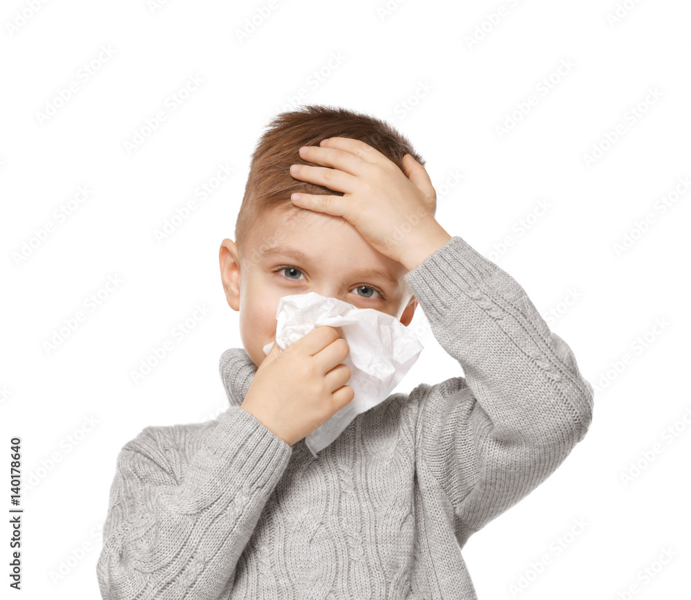 Cute little boy blowing his nose into tissue on white background Cute little boy blowing his nose into tissue on white background