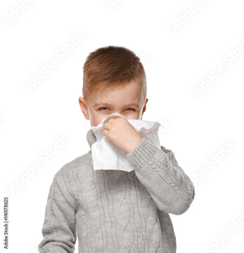 Cute little boy using tissu...