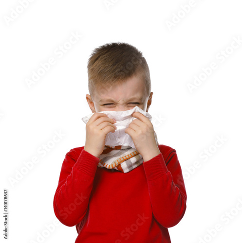 Cute little boy using tissu...