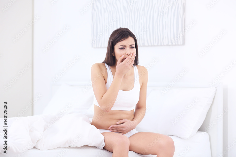 Pregnant woman suffering from nausea in morning Pregnant woman suffering from nausea in morning