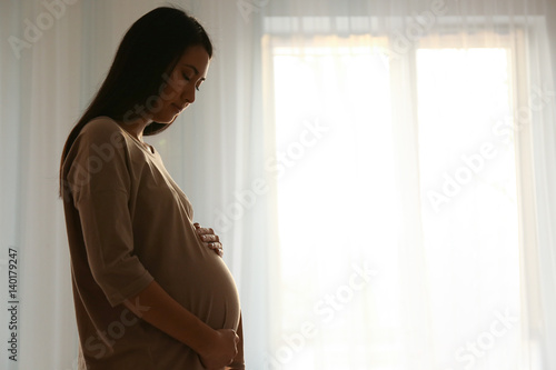 Pregnant Asian woman at home