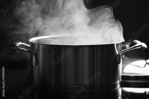 Steam over saucepan in the dark