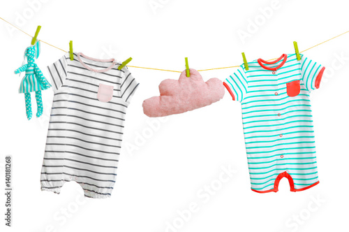 Baby clothes hanging on whi...