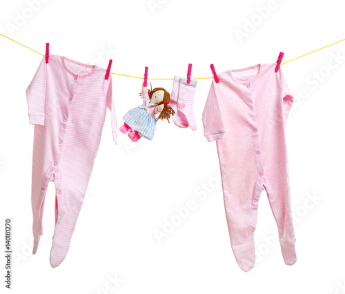 Baby clothes hanging on white background