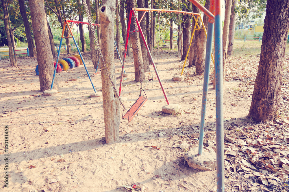 Fototapeta premium Children swing,playground in the park (vintage tone)