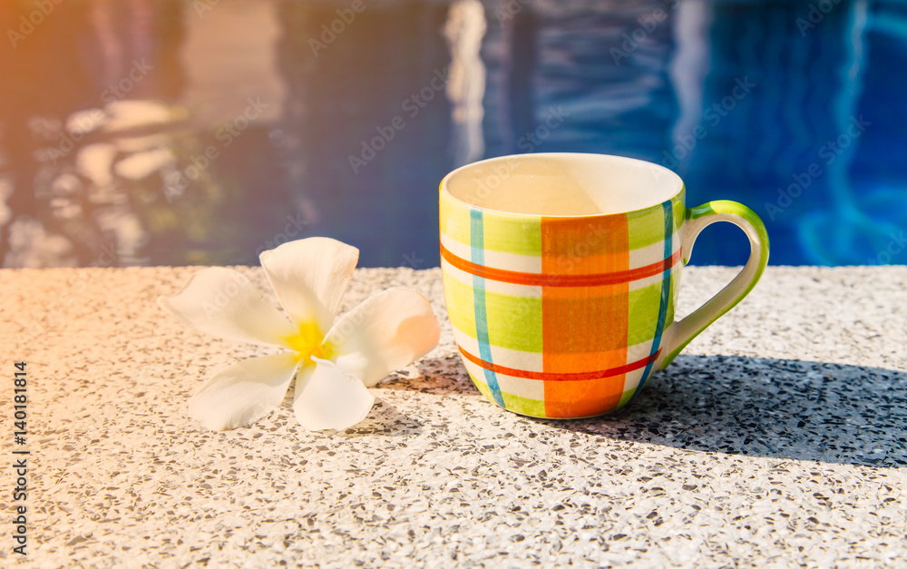 Colorful cup of coffee on the edge of pool. Colorful cup of coffee on the edge of pool.