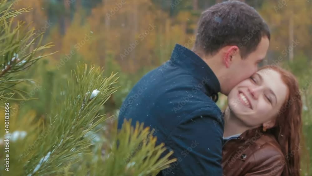Lovers Embrace Among Pine Trees During Snowfall Lovers Embrace Among Pine Trees During Snowfall