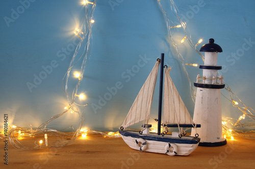 Fototapeta Naklejka Na Ścianę i Meble -  Nautical concept with sea life style objects and gold garland lights