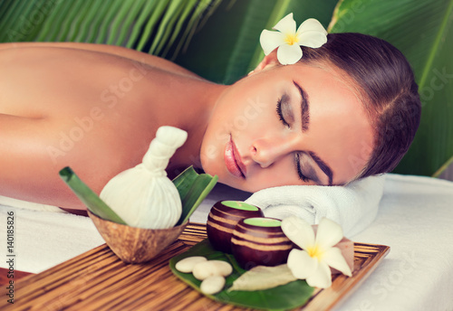 Body care. Spa body massage treatment with hot herbal ball for deep relaxation . Woman having massage in the spa salon 