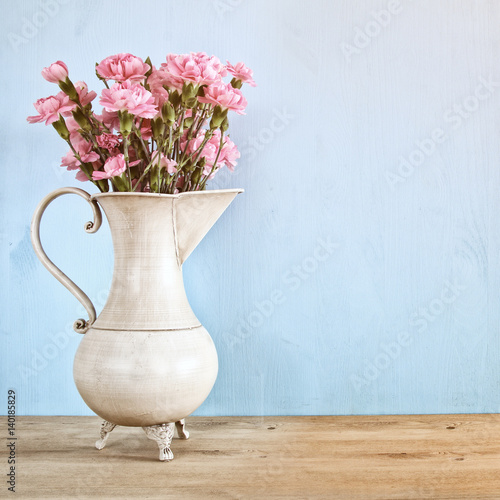 Bouquet of Carnation flowers in the vintage white vase © tomertu