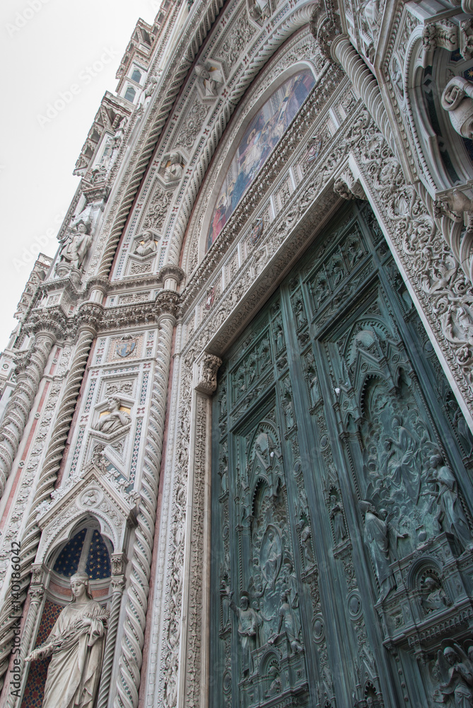 Florence cathedral entrance with detailed ornaments and white and green marble facade