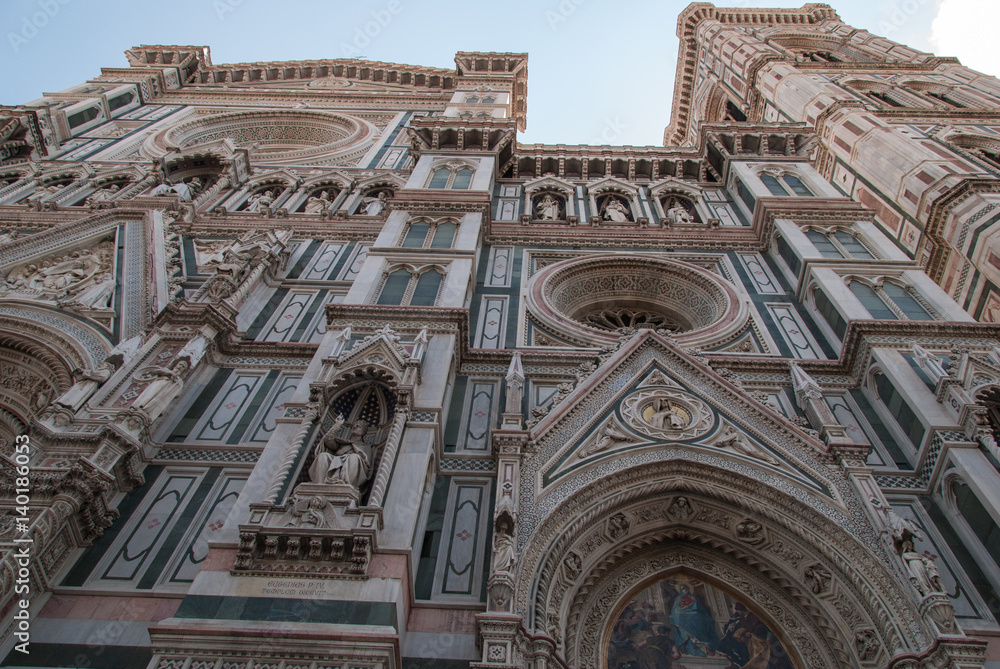 Florence cathedral entrance with detailed ornaments and white and green marble facade
