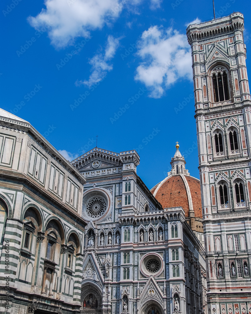 Fototapeta premium Florence cathedral with iconic duomo and white and green marble facade and clear blue sky