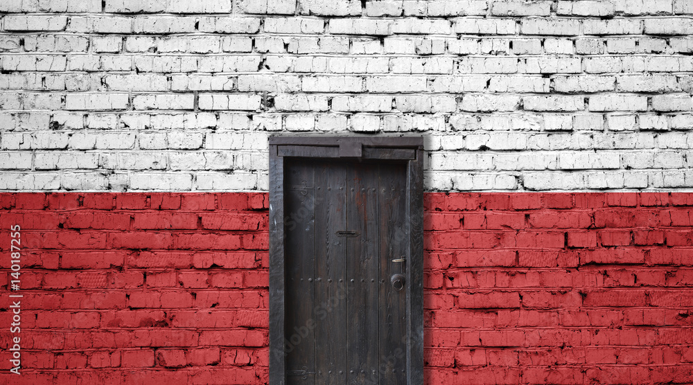 Poland flag on brick wall. Closed door in a wall Poland flag on brick wall. Closed door in a wall