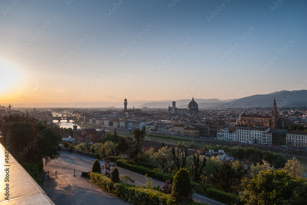 Panoramic view of Florence, Italy at dusk with iconic buildings and bridges