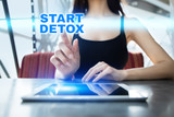 Woman is using tablet pc, pressing on virtual screen and selecting start detox.