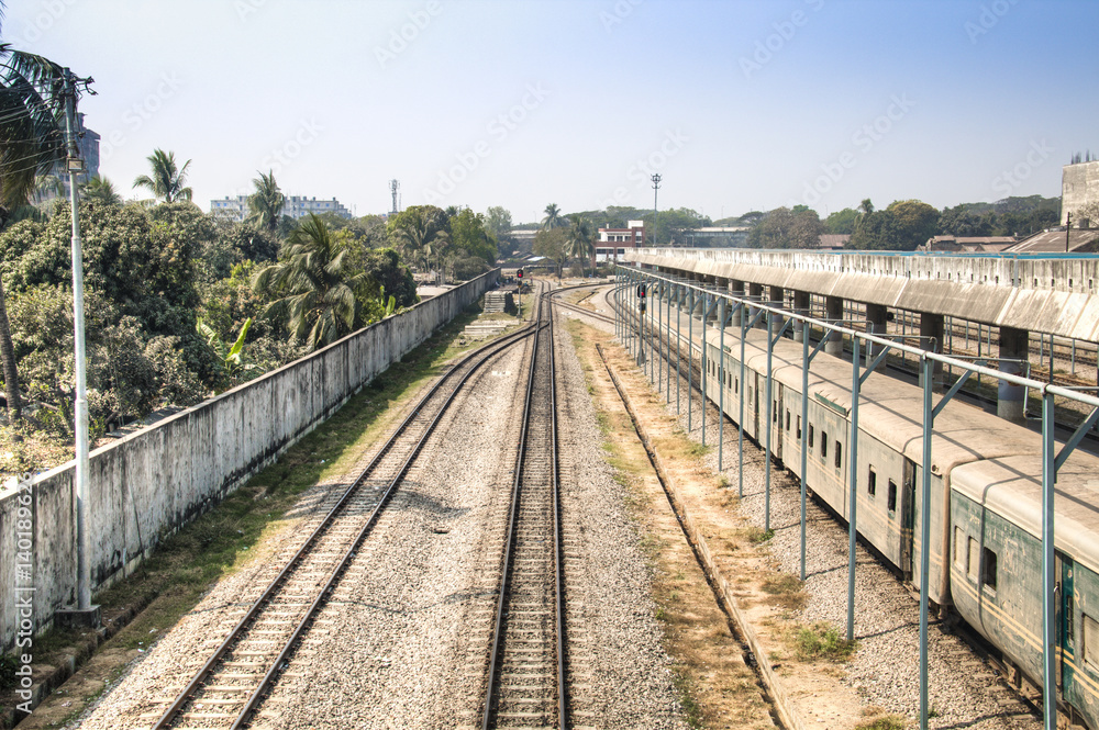Railroad tracks with a train in the station in Chittagong, the main port city of Bangladesh
Railroad tracks with a train in the station in Chittagong, the main port city of Bangladesh