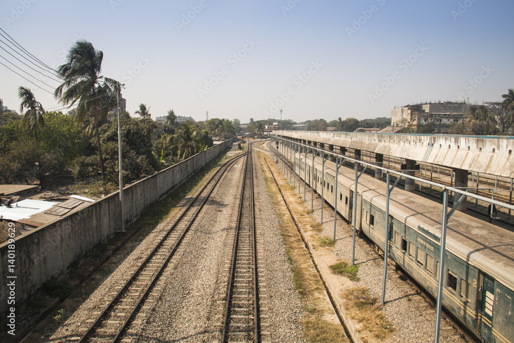 Railroad tracks with a train in the station in Chittagong, the main port city of Bangladesh
