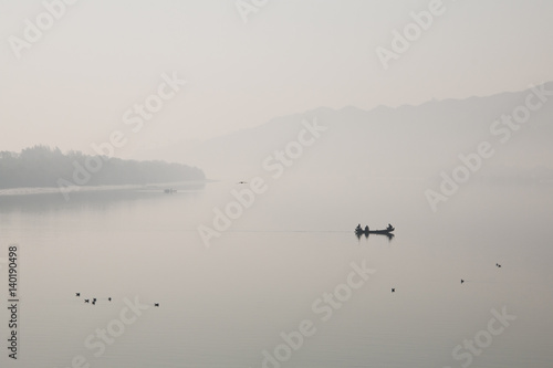 Fishermen on a small fishing boat on a river near Cox's Bazar in Bangladesh 