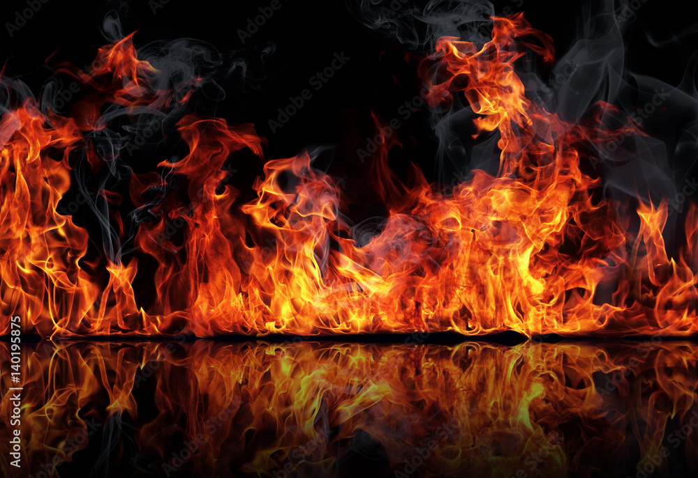 The texture of fire on a black background is reflected in a glossy table. The texture of fire on a black background is reflected in a glossy table.