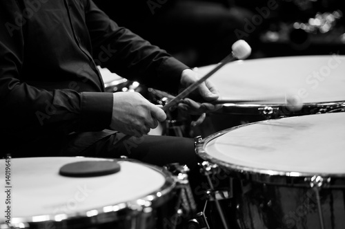  Hands musician playing the timpani in the orchestra closeup in black and white