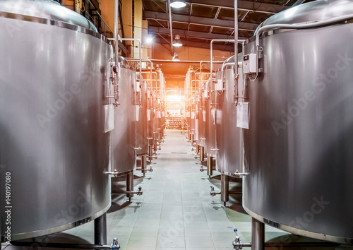 Rows of steel tanks for beer fermentation and maturation. photo
