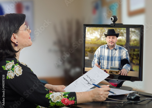 Telemedicine doctor reviews blood pressure graph of rural patient 