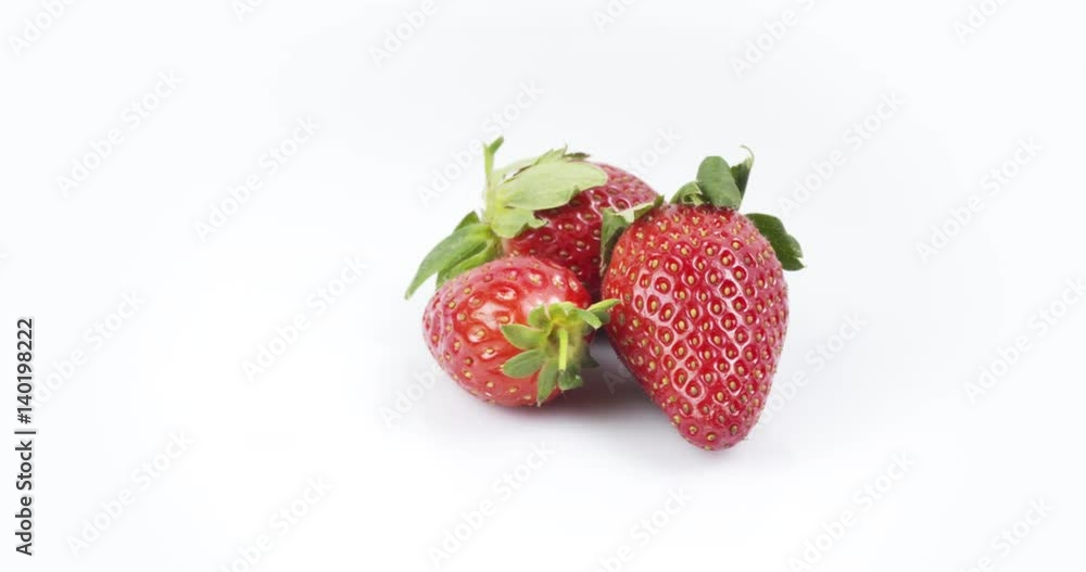 Three fresh strawberries rotating on white background loopable, 4k prores footage Three fresh strawberries rotating on white background loopable, 4k prores footage