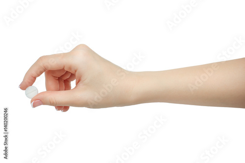 Hand holding a pill between thumb and forefinger isolated on white background. manicured hand