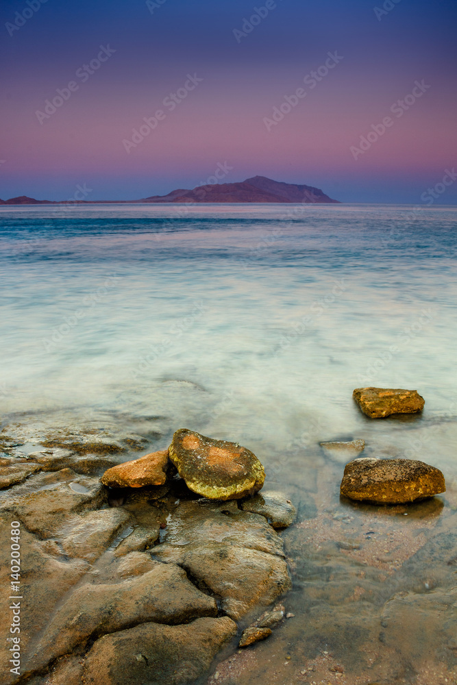 Landscape of Red Sea coastline at sunset. View of Tiran island on the horizon. Sharm El Sheikh. Egypt.  Effects  a long exposure shot.