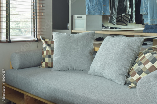 Gray color cushion with wooden base and pillows