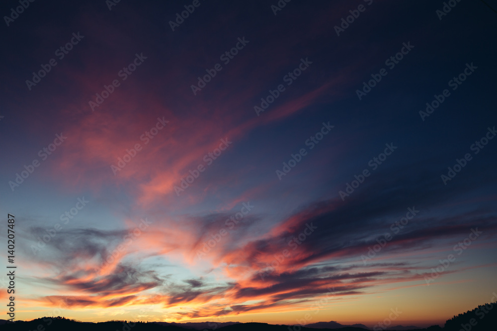 Beautiful red sunset over the field and forest Beautiful red sunset over the field and forest