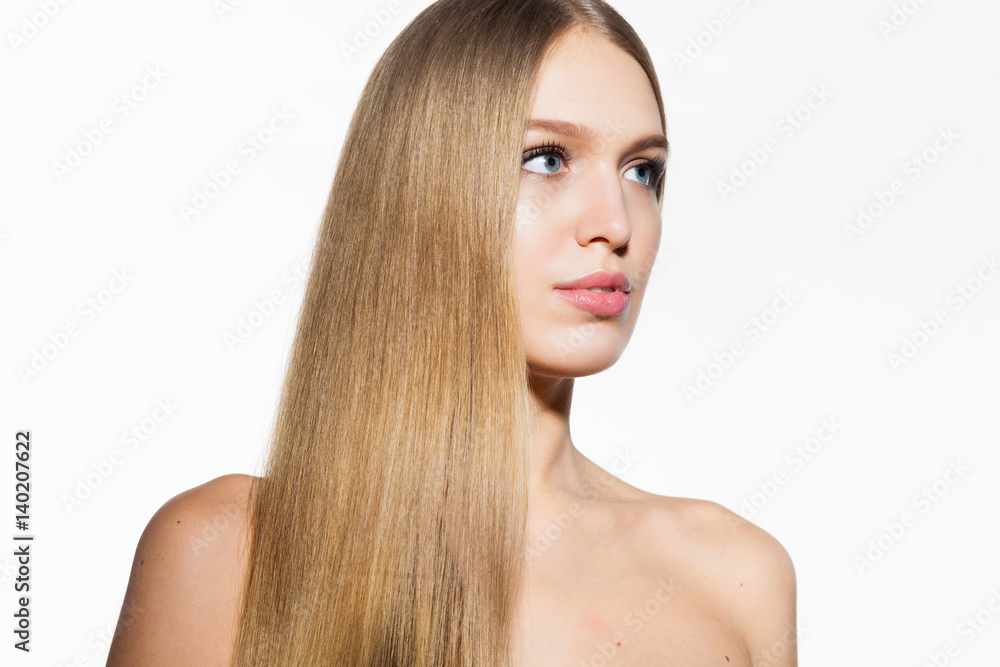 Fototapeta premium Beauty portrait of blonde model woman with long shiny hair and healthy skin looking at camera on white background