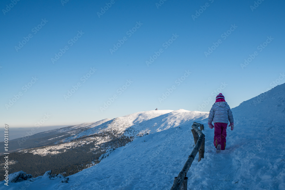 Girl on a mountain trail in winter