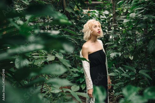 Fashion model posing in tropical botanic garden