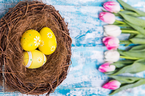 Happy Easter background, eggs, nest, tulips photo