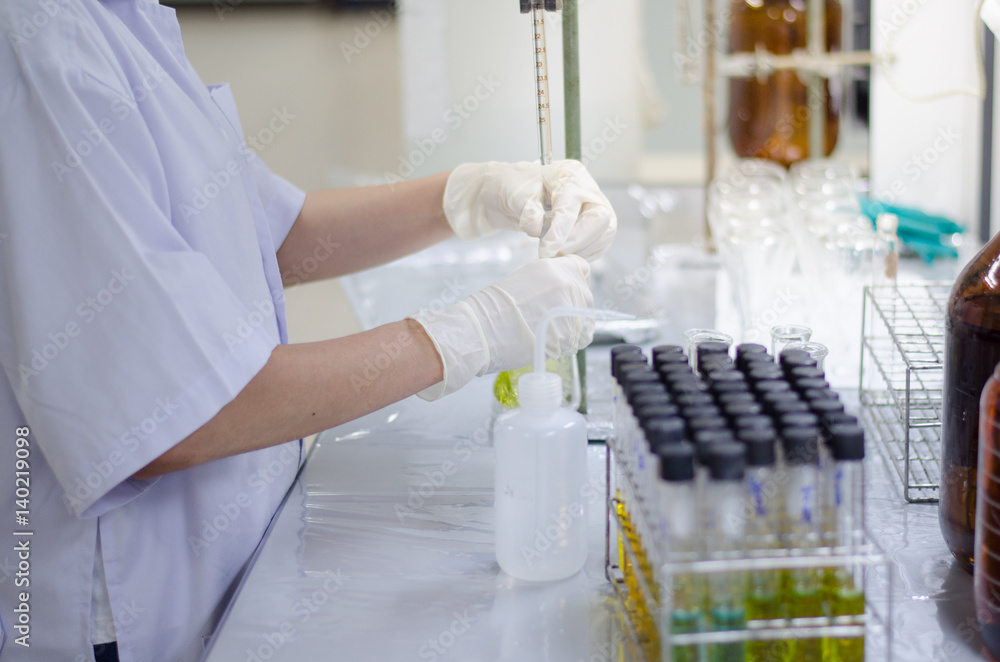 Scientist hand titration at laboratory, titrate chemical, titration with burette and erlenmeyer