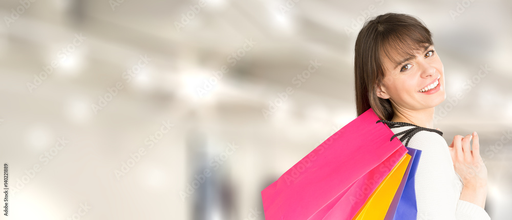 Beautiful and smiling young woman doing shopping in the mall. Beautiful and smiling young woman doing shopping in the mall.