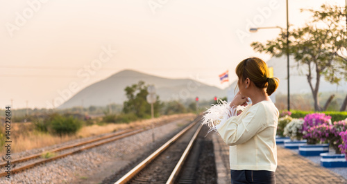 woman waits train on railway platform