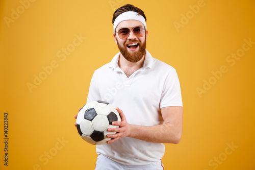 Happy bearded sportsman holding soccer ball © Drobot Dean