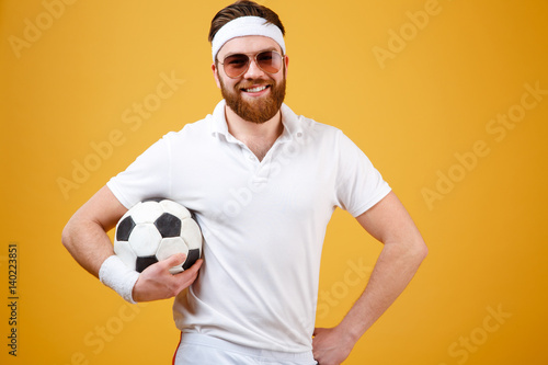 Smiling bearded sportsman holding soccer ball © Drobot Dean